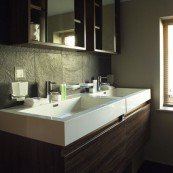 alt="Sink and Luxury Toiletries in Hotel Bathroom"