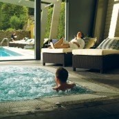 alt="Couple relaxing in indoor swimming pool "